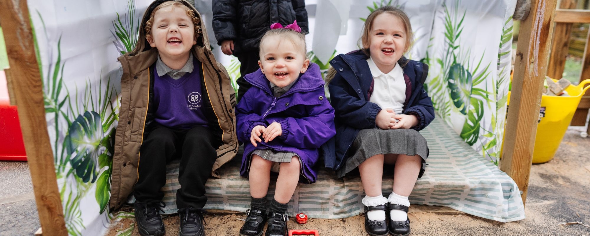 Header image showing children on tricycles